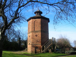 exterior view of the dovecote amongst the trees in the grounds of the hall