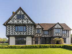 external view of the hall revealing all the patterning resulting from the timber framed construction